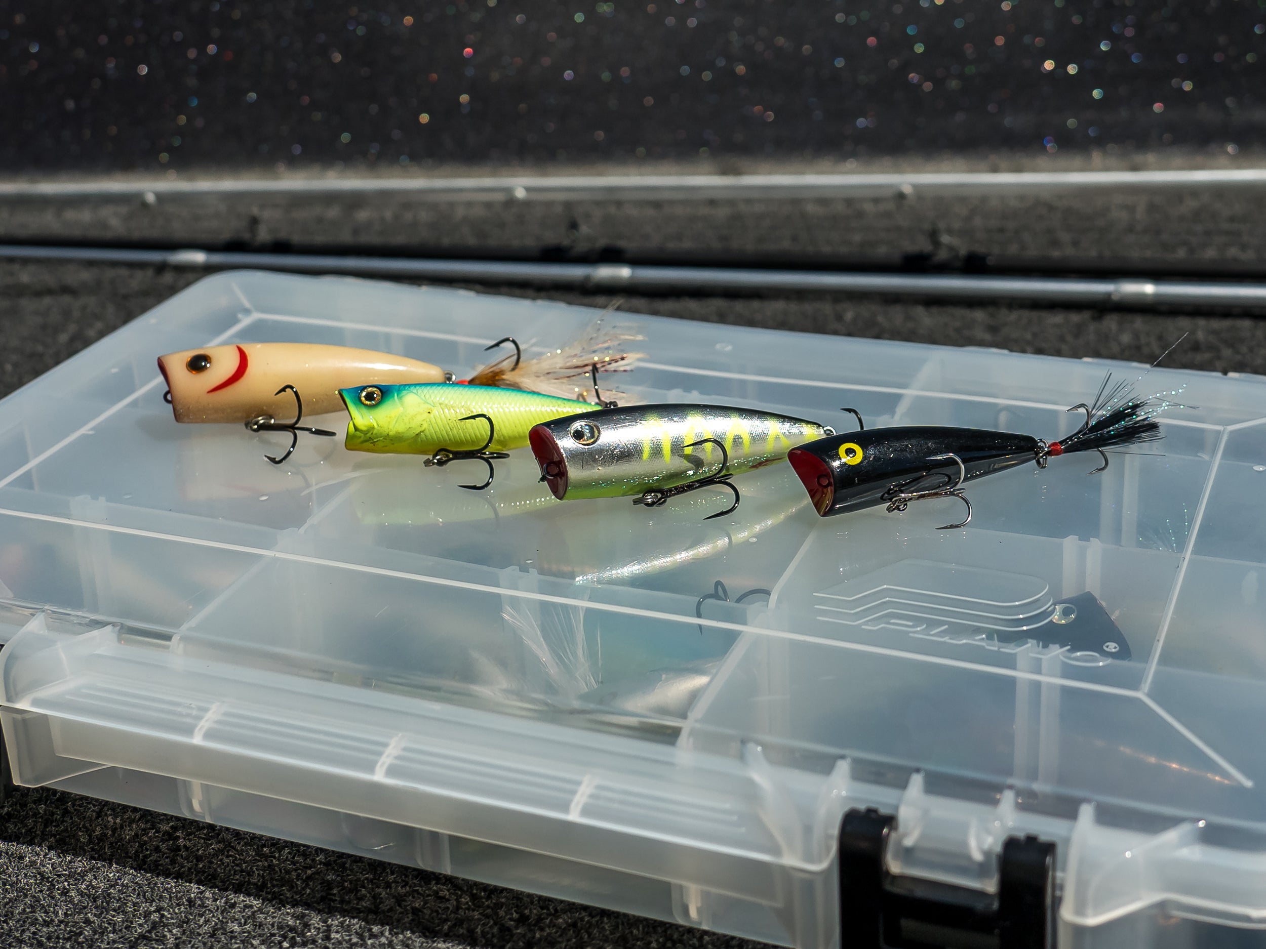 four poppers lined up on a tackle box